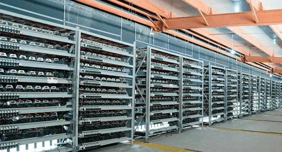 Rows of mining hardware racks inside a large building